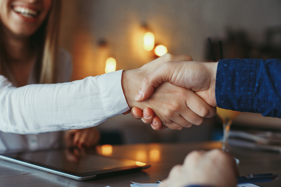 Businessman and businesswoman handshake