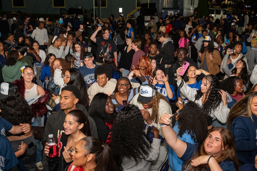 Students celebrate together at the nighttime Homecoming pep rally