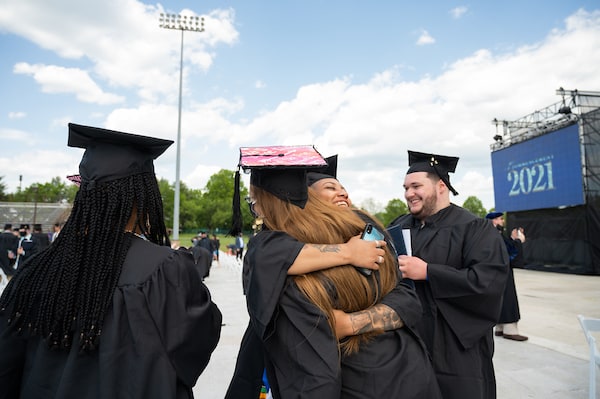 Graduates hugging